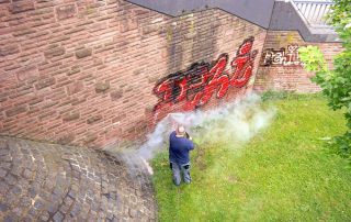 A worker washes a wall